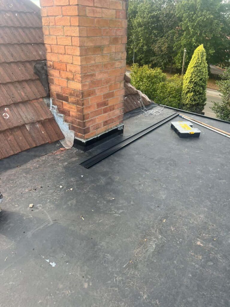 This is a photo of a flat roof which has just been repaired, there is also a chimney stack and some leadwork has also been dressed. Works carried out by Clay Cross Roofing Repairs